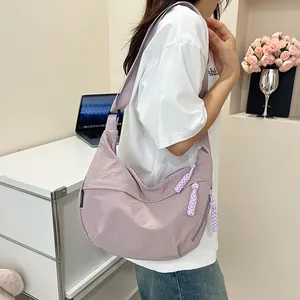 Dettaglio della borsa a mezzaluna in nylon lilla con tirante della zip a corda intrecciata