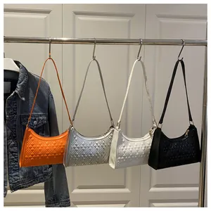 Detail of hobo bags in four colors featuring 3D geometric quilted texture and metal hardware