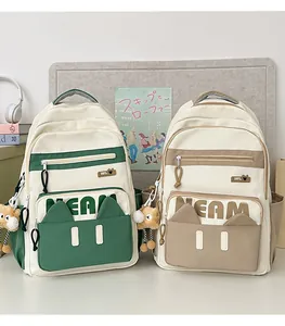 Macro detail of canvas school backpacks with cute cat ears and plush bear charms
