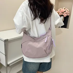 Borsa a mezzaluna in nylon lavanda su modella con dettaglio della cerniera intrecciata