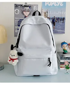 Detail of minimalist nylon school backpack with plush dog charm in a student room