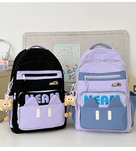 Detail of Korean style school bags with cat-ear design and cute bear plush charms
