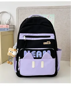 Detail of canvas backpack featuring cat ear design, NEAM logo and plush bread keychain
