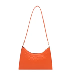 Chic orange crescent underarm bag with embossed diamond texture and slim shoulder strap