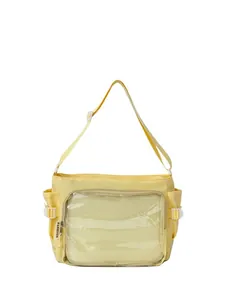 Detail of bright yellow crossbody bag featuring transparent front pocket and side buckle