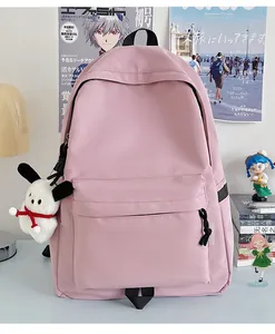 Close-up of light pink nylon backpack with cute white puppy plush keychain on the front pocket
