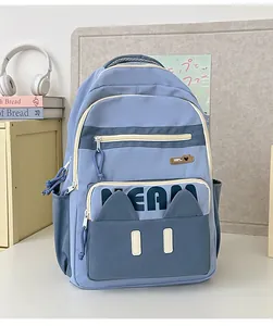 Detail of grey-blue school backpack featuring cat ears and multi-pocket design