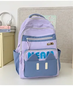 Detail of lavender and blue nylon backpack featuring cartoon cat ears and NEAM embroidery