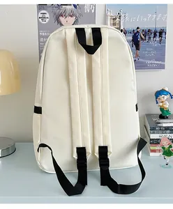 Detail view of cream nylon backpack with adjustable black straps and side pockets