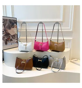 Detail view of crescent shoulder bags in six colors with golden H-shaped buckles