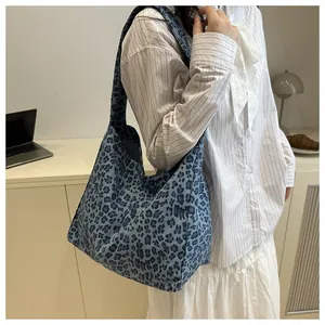 Detailed shot of large blue leopard print canvas tote bag with wide shoulder strap