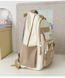 Detailed side view of beige and khaki school backpack with multi-pocket functional design