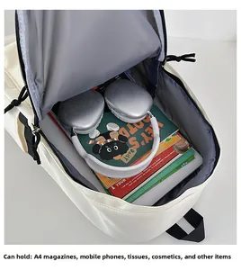 Detail view of cream white nylon backpack showing large interior space for A4 magazines