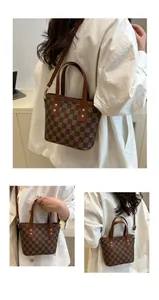 Detail view of vintage brown checkered bucket bag with gold hardware and shoulder strap