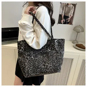Detailed view of large leopard print canvas tote bag with front pocket and shoulder straps