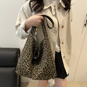 Stylish large leopard print canvas tote bag shown by model in minimalist interior