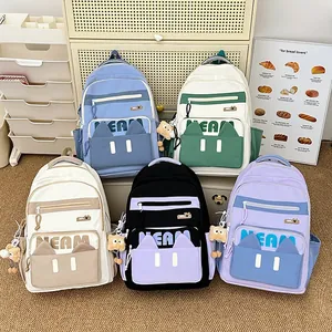 Minimalist high-capacity student backpacks in five pastel colors with cute bear pendants