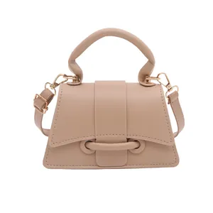 Beige minimalist trapezoid handbag with top handle and adjustable shoulder strap