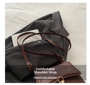 Details des bequemen Schultergurts und der Gold-Hardware an brauner Ledertasche