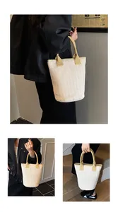 Detail of beige woven bucket bag featuring sturdy yellow fabric handles for vacation