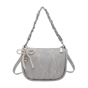 Grey pleated leather handbag with silver chain strap and pearl bow charm accessory
