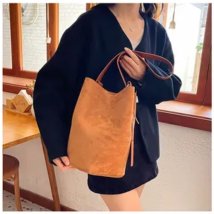 Brown suede tote bag shown on model for professional commuting and daily styling