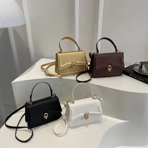 Schicke Damen-Umhängetaschen in Gold, Braun, Schwarz und Weiß auf minimalistischem Display