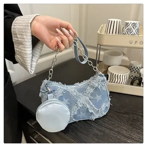 Dettaglio borsa in denim con patchwork di stelle sfrangiate e portamonete rimovibile