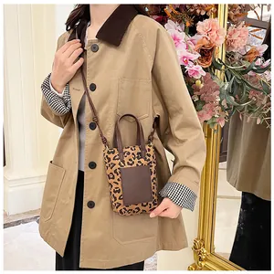 Mini leopard print crossbody bag with brown leather patch on khaki jacket lifestyle
