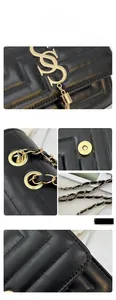 Detail of black quilted leather handbag showing golden logo, tassel and magnetic closure