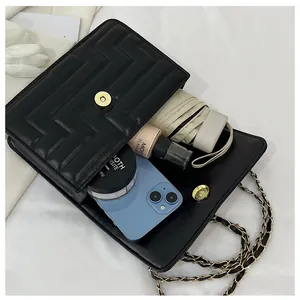 Internal view showing storage capacity of black quilted crossbody bag for daily essentials