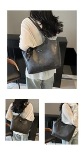 Close-up of black PU leather tote bag featuring a metal nameplate and woven rope charm