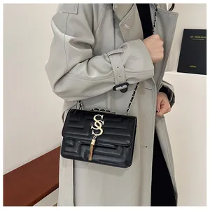 French style black crossbody bag with gold hardware, S-buckle and tassel details