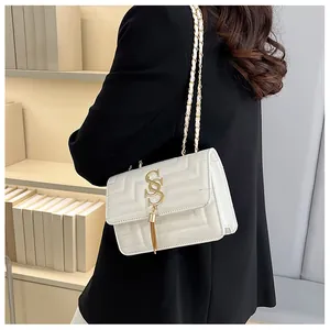 French style white crossbody bag with gold chain strap and quilted stitching on the side