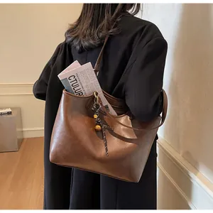 Detail view of large brown vintage tote bag with fashion tag and spacious interior