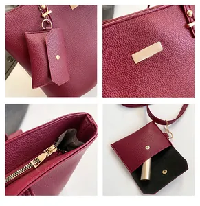 Detail view of burgundy tote bag with pebble leather texture and gold metal hardware