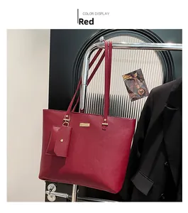 Detail of red minimalist tote bag with textured surface and hanging coin purse accessory