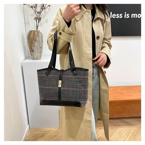 Chic houndstooth plaid tote bag with black leather accents and golden twist lock closure