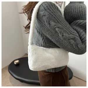 Detail shot of the white plush faux fur texture on this trendy winter underarm bag