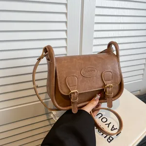 Minimalist brown vintage saddle bag for women with fashion embossing and metal buckle