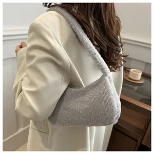 Close-up of light grey faux fur shoulder bag with dense plush texture and soft handle