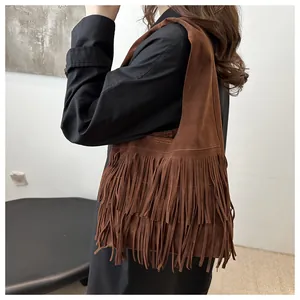 Detail of brown faux suede shoulder bag featuring three layers of long retro fringes