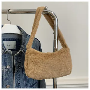 Detailed close-up of a soft khaki faux fur hobo bag hanging on a metal display stand