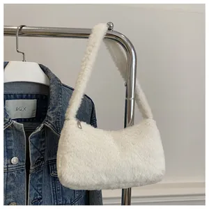 Detail of soft white faux fur shoulder bag with silver zipper and fluffy texture