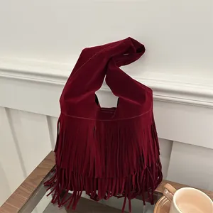 Burgundy suede tote bag with fringe details and a unique knotted handle for women