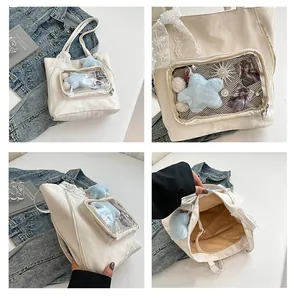 Macro details of beige ita bag with transparent PVC display window and lace ribbon decoration