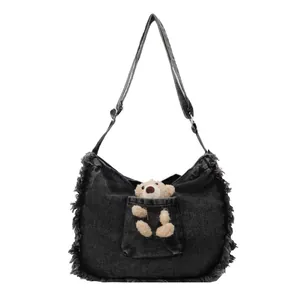 Washed black denim tote bag with cute plush bear and distressed fringe edges