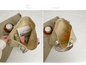 Detail view of the spacious beige woven tote bag interior with magnetic closure