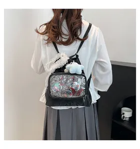 Detail of black ita bag featuring a clear PVC window and delicate white lace trim