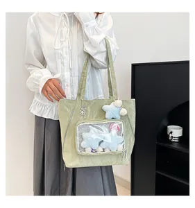 Detail of light green nylon tote with transparent pocket and star plush accessory